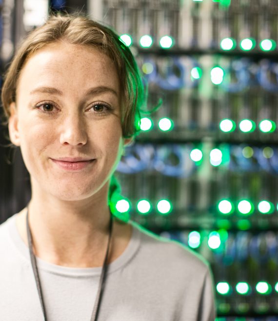 Caucasian woman technician in a large computer server farm.